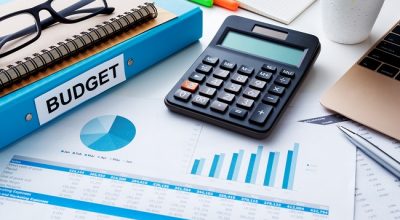 Financial and budget planning concept with calculator  notebook and financial chart report on work desk